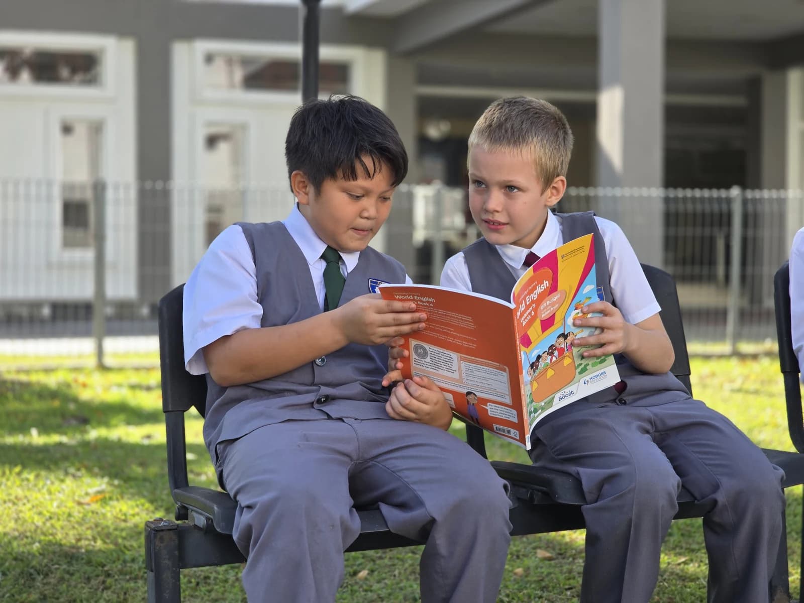 KS International School pupils reading a Cambridge Primary book together